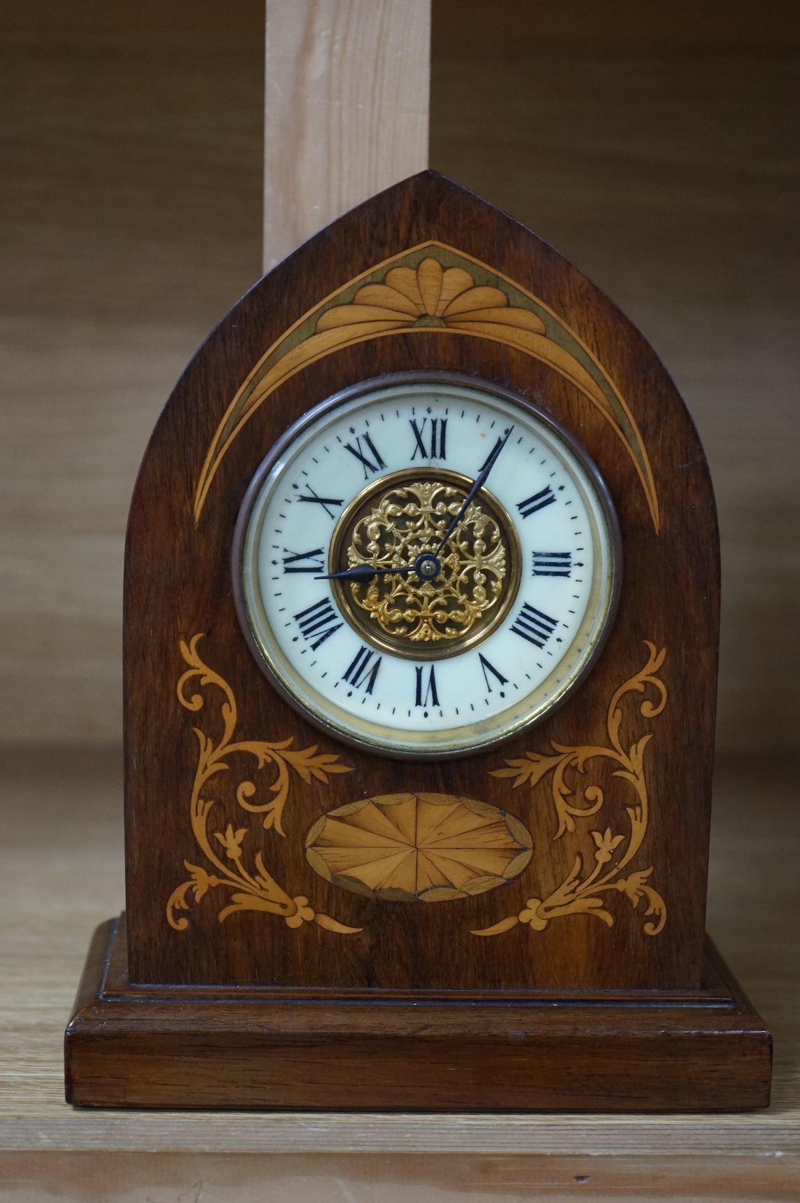 An Edwardian inlaid mahogany lancet shaped eight day mantel timepiece, with key, 23cm high
